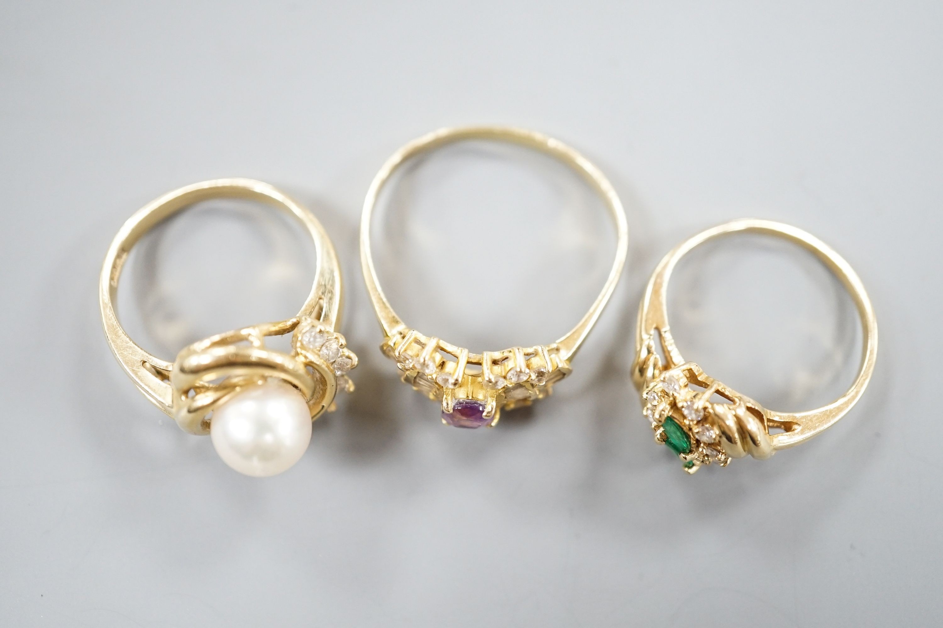 Three assorted modern 14k yellow metal and gem set dress rings, including cultured pearl and diamond, gross weight 10 grams.